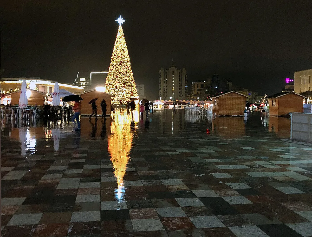 Illuminated wooden stalls at a German Christmas market in the evening — 2