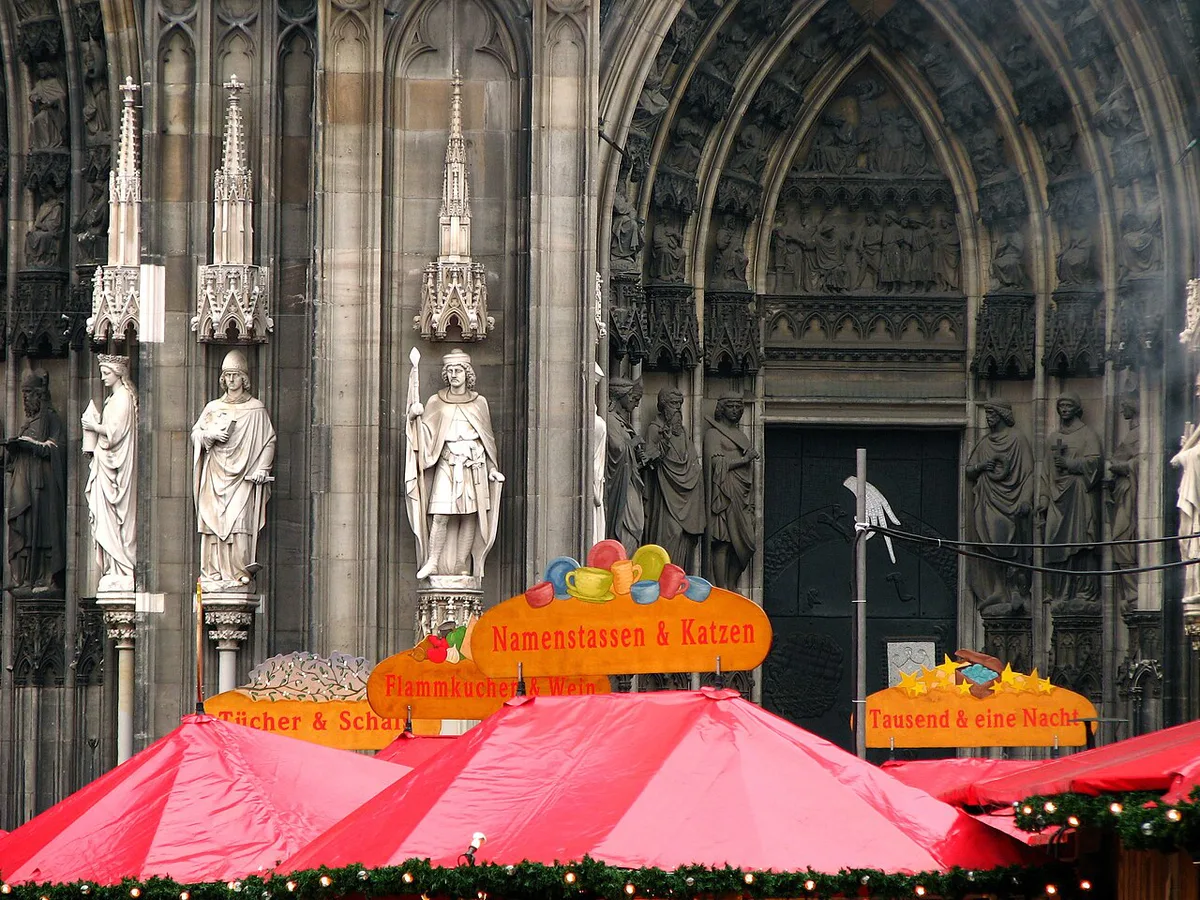 The Christmas market stalls beneath Cologne Cathedral at night — 1