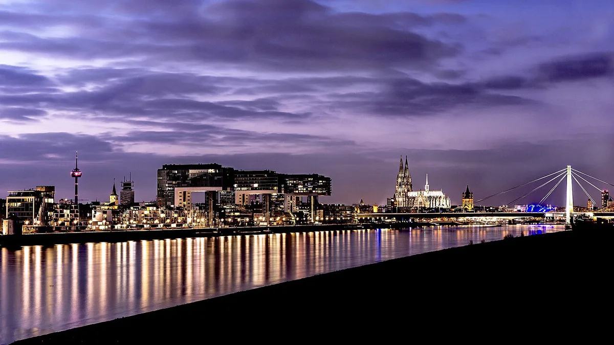 Cologne Cathedral above the old town with crowds below — 1