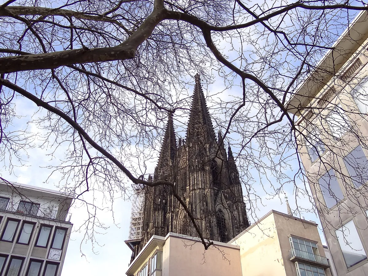 Cologne Cathedral above the old town with crowds below — 2